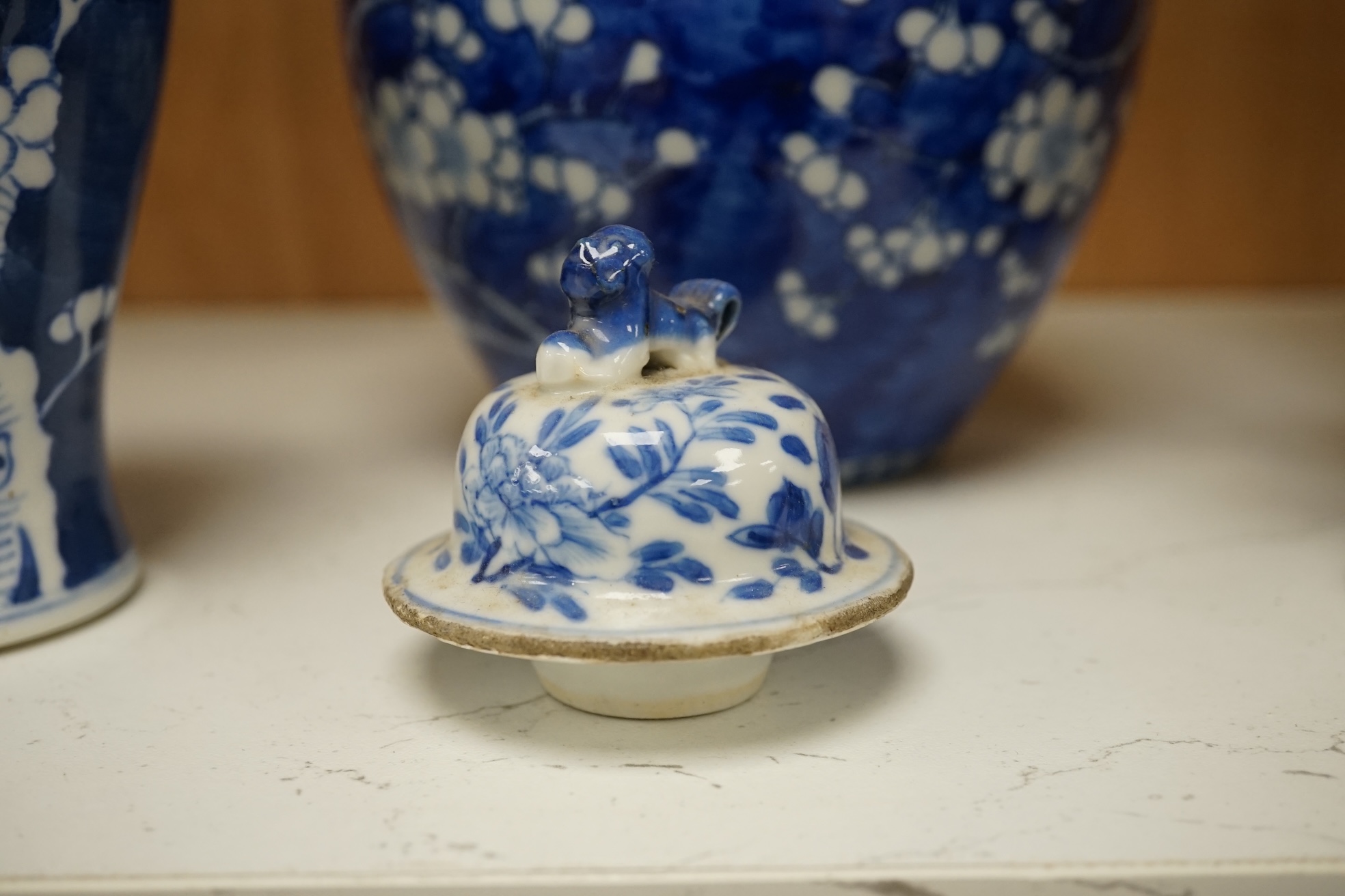 Two Chinese prunus jars and two vases, early 20th century, tallest 26cm, together with two Chinese Yixing pottery teapots, one Republic period, tallest 12.5cm. Condition - varies, poor to fair